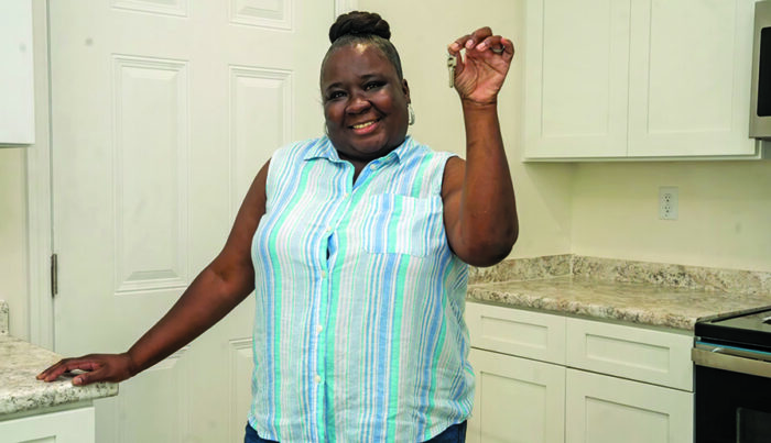 Tamicka Newberry holding up keys to new house