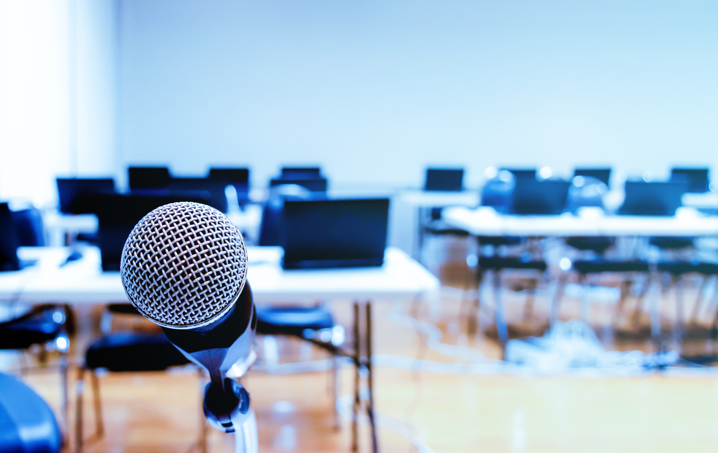 Close up microphone with laptop on table background in seminar room.