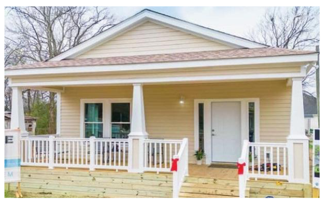 Front view of house with red bows tied on railing to front door.